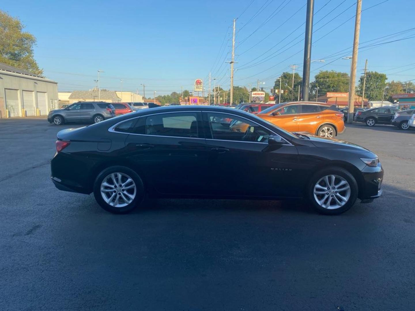 2016 BLACK CHEVROLET MALIBU LT (1G1ZE5ST4GF) with an 1.5L engine, Automatic transmission, located at 3100 Covert Avenue, Evansville, IN, 47714, (812) 473-4492, 37.955418, -87.512238 - Photo#2