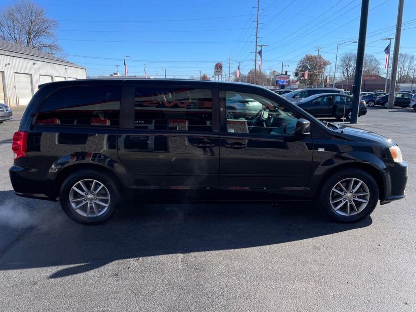 2014 BLACK DODGE GRAND CARAVAN SE (2C4RDGBG3ER) with an 3.6L engine, Automatic transmission, located at 3100 Covert Avenue, Evansville, IN, 47714, (812) 473-4492, 37.955418, -87.512238 - Photo#2